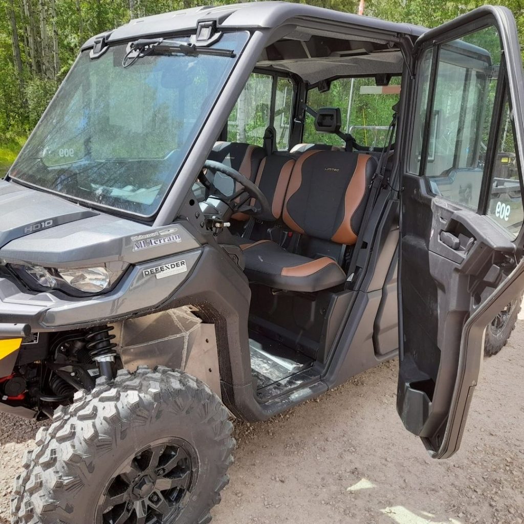 Grey UTV with enclosed cab door open