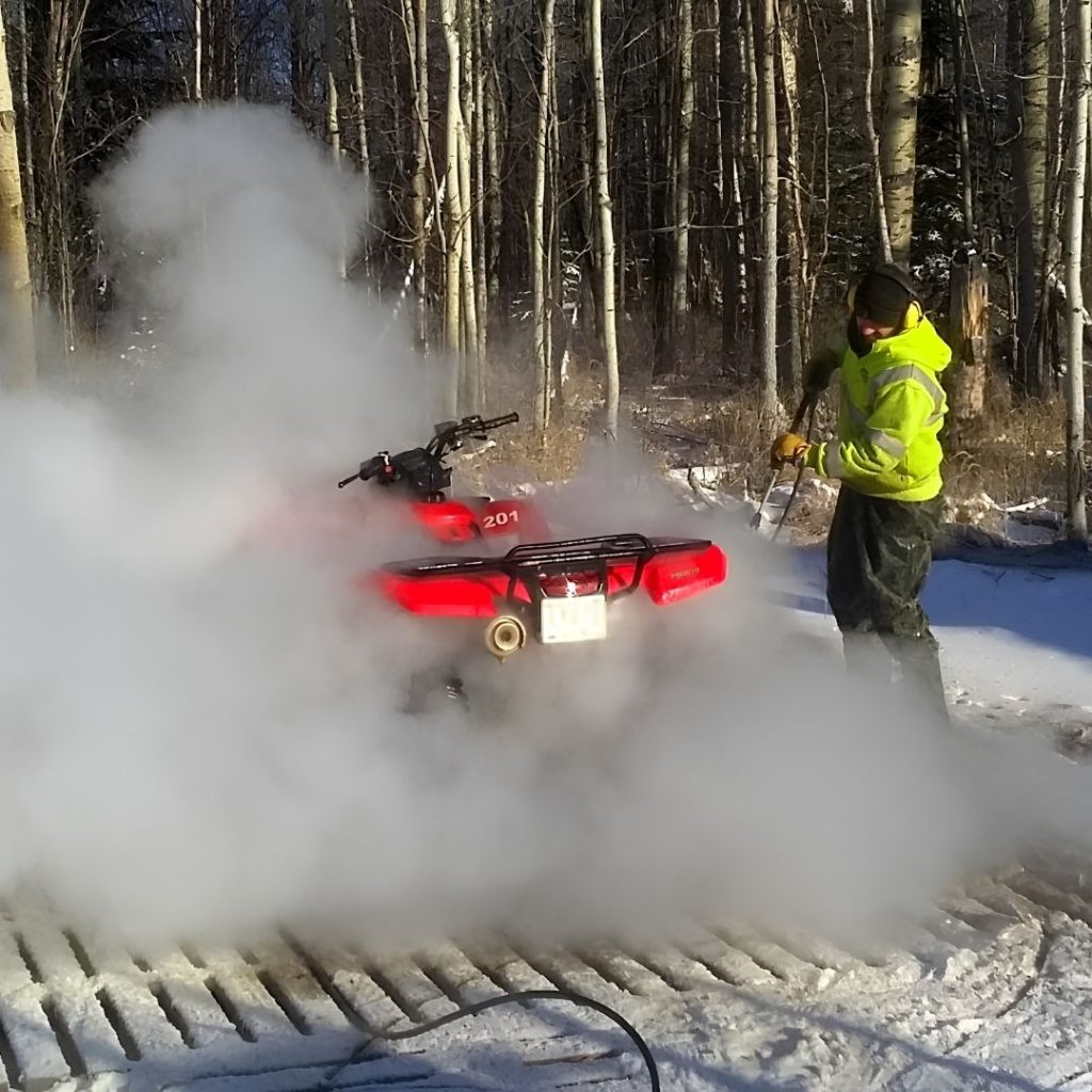 Red ATV being washed after use