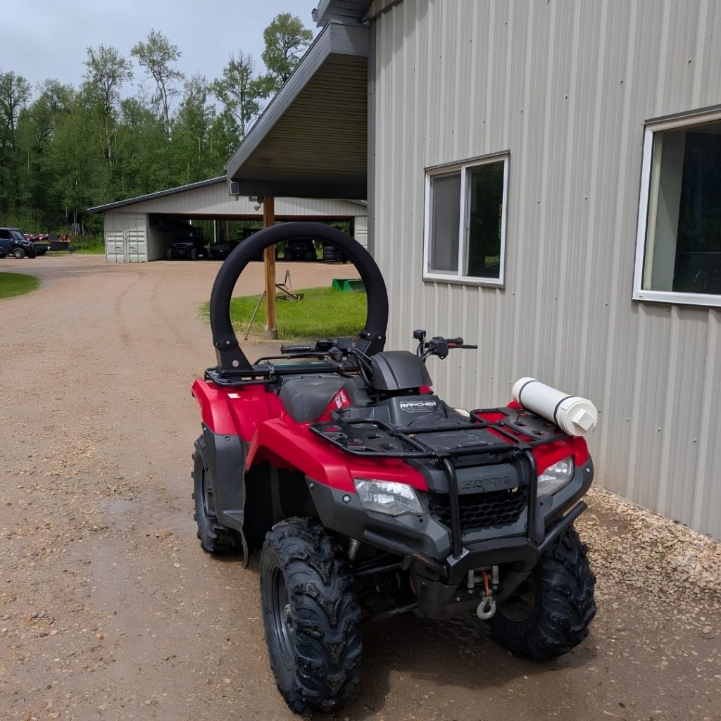 Red ATV parked on a gravel road in Alberta